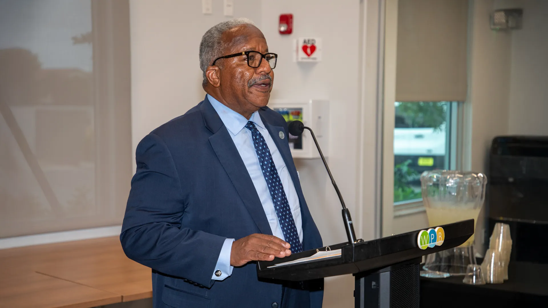 Mayor of West Palm Beach speaking in front of a group of people.