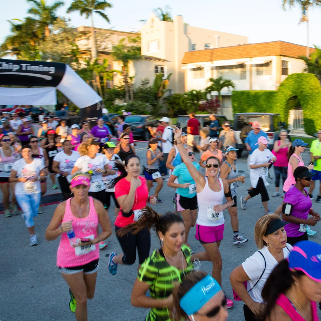 Group of women energetically running together in a race.